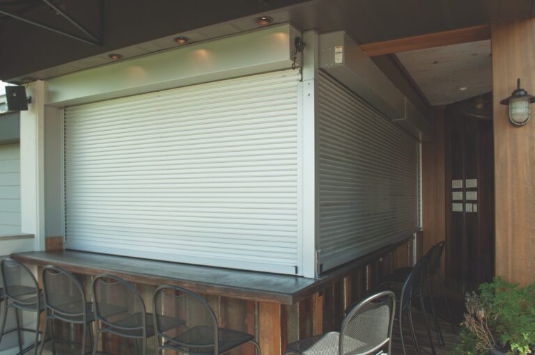 counter rolling door model 651 by Overhead Door Company of Huntsville/North Alabama in white surrounding by stainless steel. it is in a restaurant
