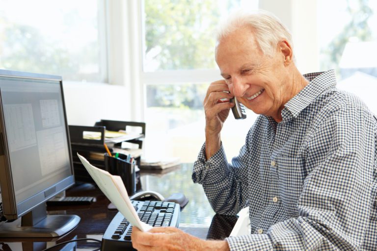 Commercial Architect looking at a bill and smiling