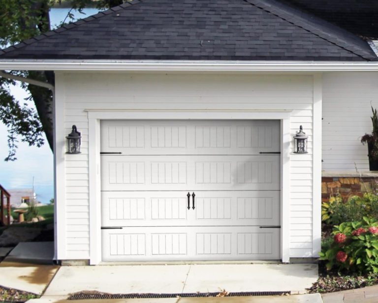 White Traditional Steel Garage Door From Overhead Door Company of Huntsville/North Alabama. This home is in Huntsville, Alabama in Madison County. Surrounding by a backdrop of blue skies along the river. The garage door is white with black hinges and lift knobs.