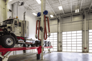 Aluminum-521-Anodized-autoshop-Edmonton-inside-2 a Truck repair shop. A very modern and clean looking building with this glas aluminum door using a Overhead Door Brand Operator.