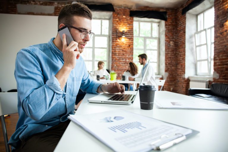 Man having lunch while calling Overhead Door for a new garage door quote