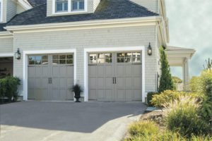 A garage door service offered by Overhead Door Company of Huntsville. A beautiful new garage door Installation of a Carriage House Style door. Color is taupe with short windows at the top. This is a garage door service offered by Overhead Door Company of Huntsville.