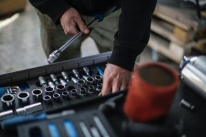 Commercial Service Technician organizing his tools for Overhead Door of Huntsville before installing a new garage door and operator at an Industrial plant.