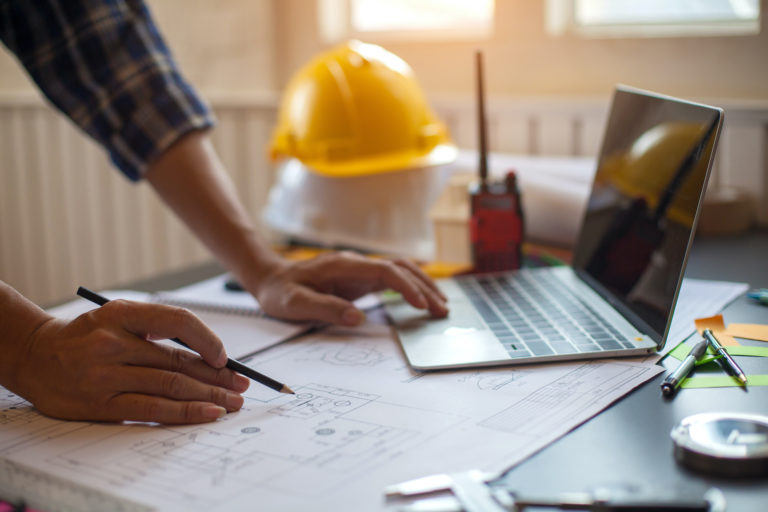 Overhead Garage Door Services - a technician studying plans for installation of a new garage door