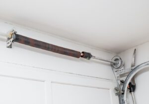 A broken single garage door spring. The question is should you open the garage door with a broken spring. 